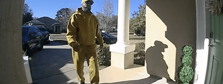 Person in yellow outfit at doorstep.